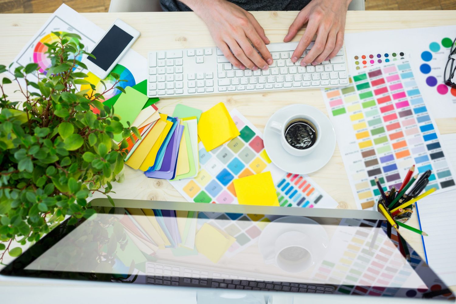 Hands of male graphic designer using computer in office